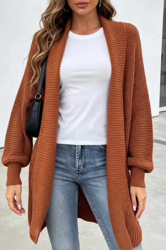 Model wearing the rust cardigan with a full-length white tee