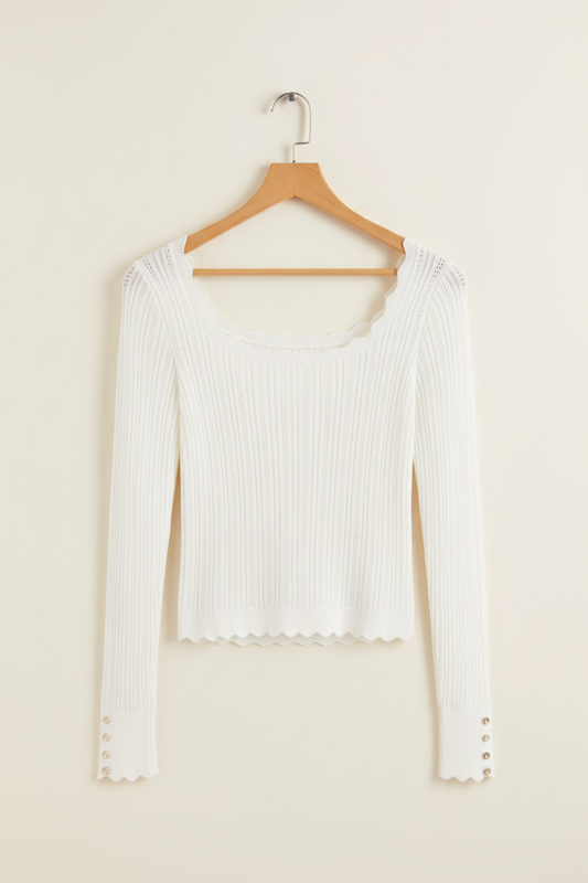 Exact white scalloped knit top on a wooden hanger