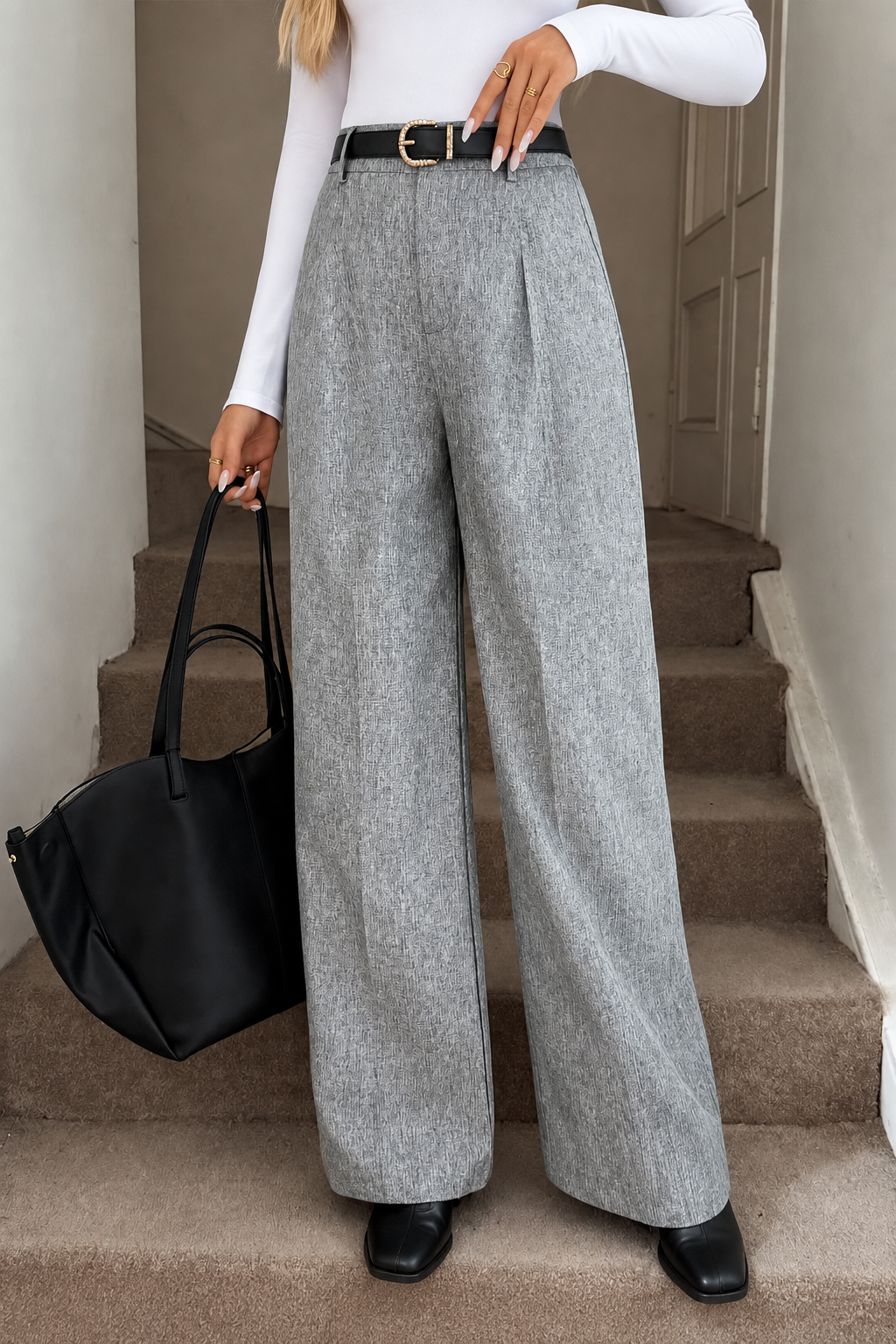 Grey wide-leg pants styled with a white shirt and black boots