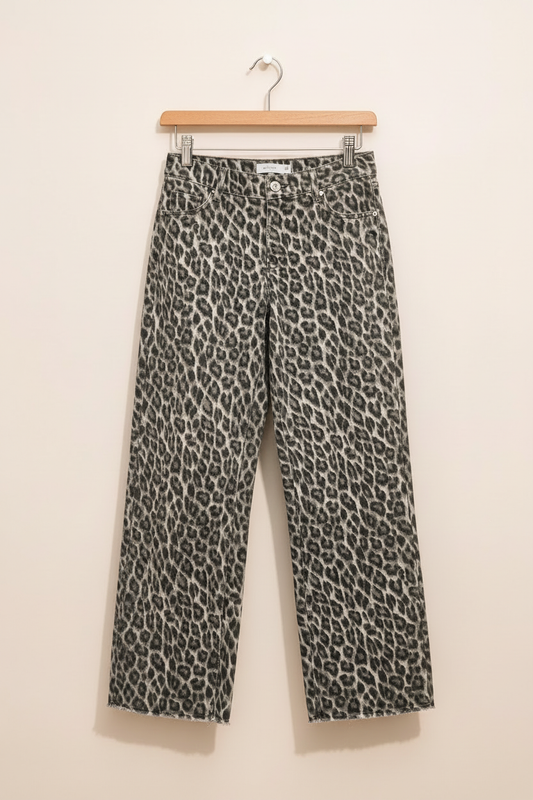 Leopard-print jeans on a clean warm-white background