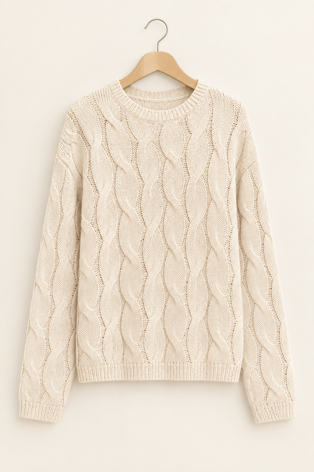 Professional cream cable-knit sweater on a hanger